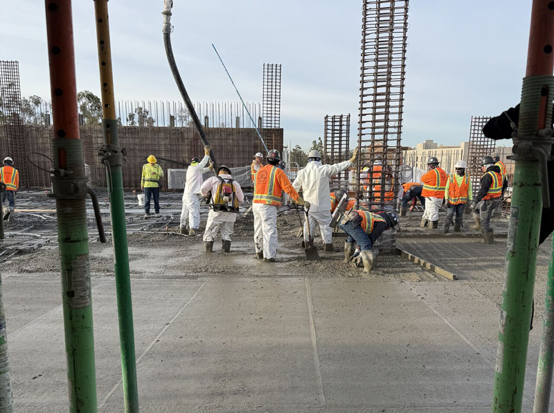 crew pouring concrete on deck